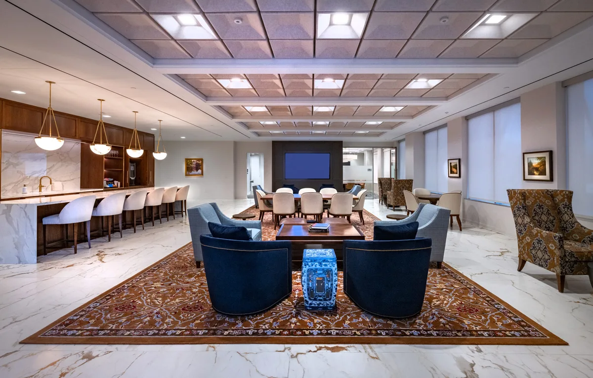Client lounge with patterned rug and seating